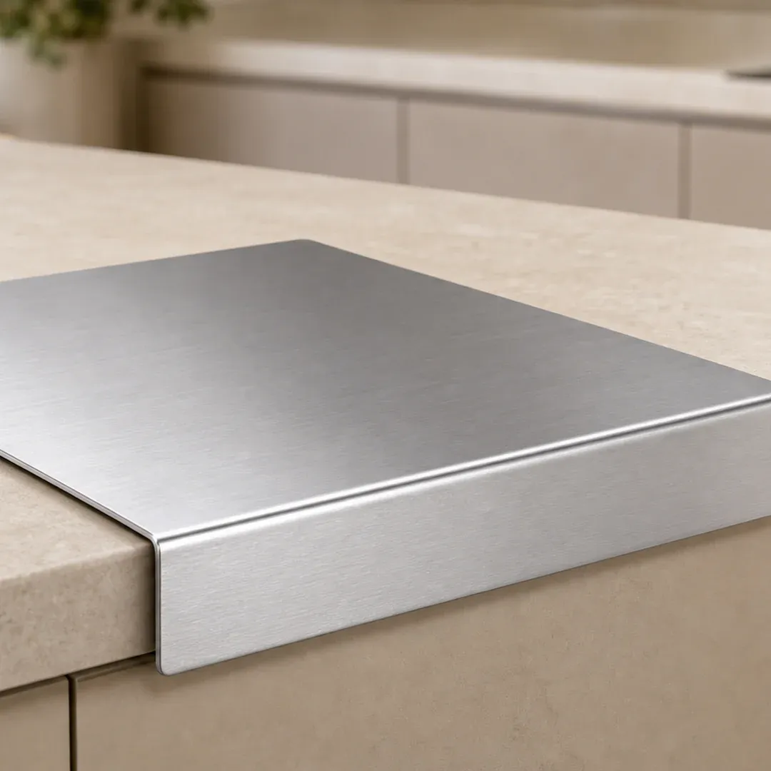 Stainless steel preparation board on a clean kitchen counter